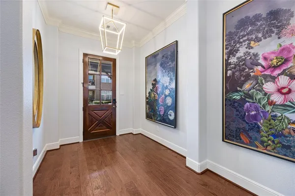 a view of a hallway with wooden floor and a workspace