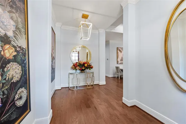 a view of a hallway to a livingroom with furniture and a mirror