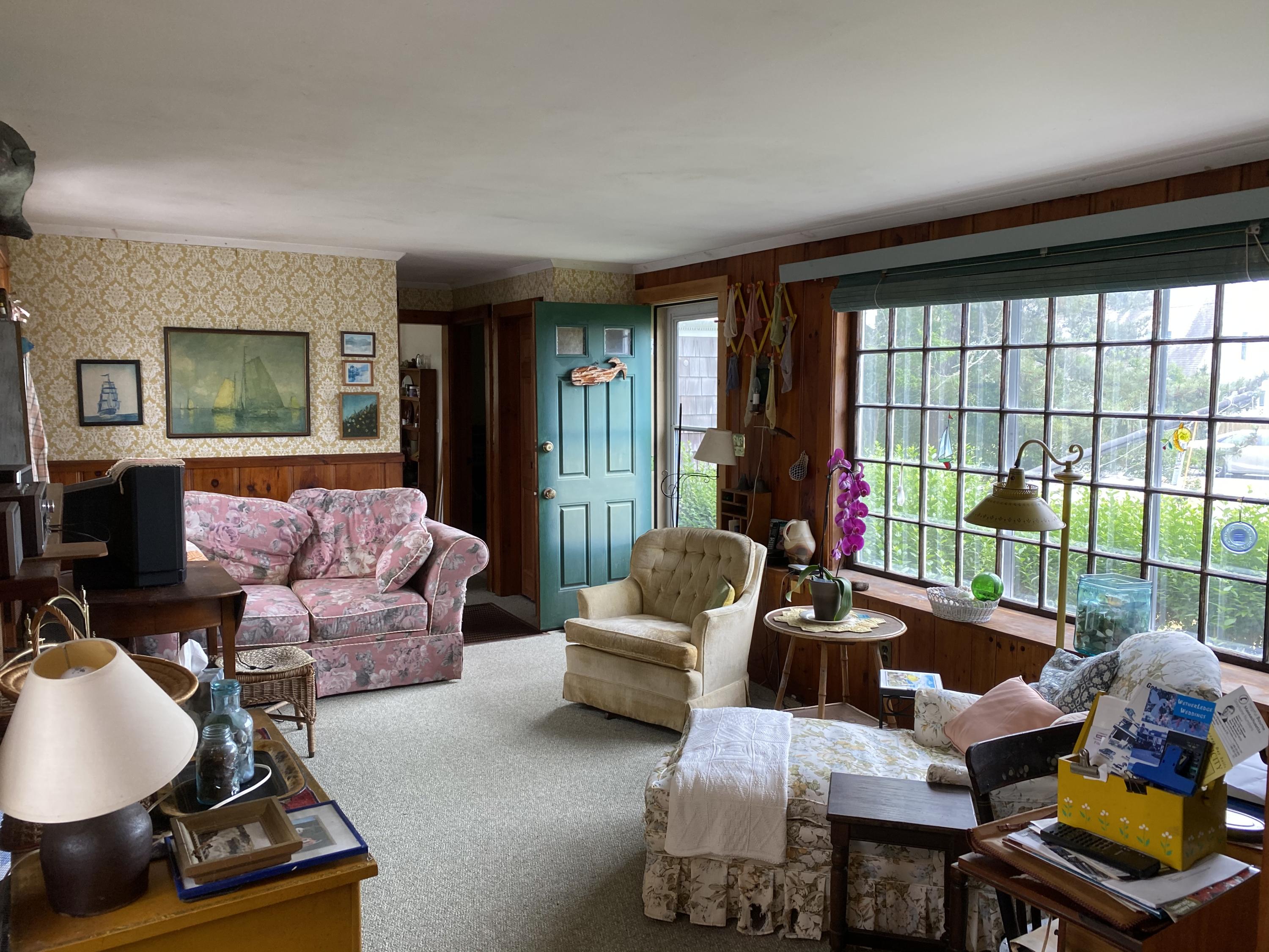 146 Mashnee Road Bourne, MA 02532 - Photo 11 of 32 a living room with furniture and a floor to ceiling window