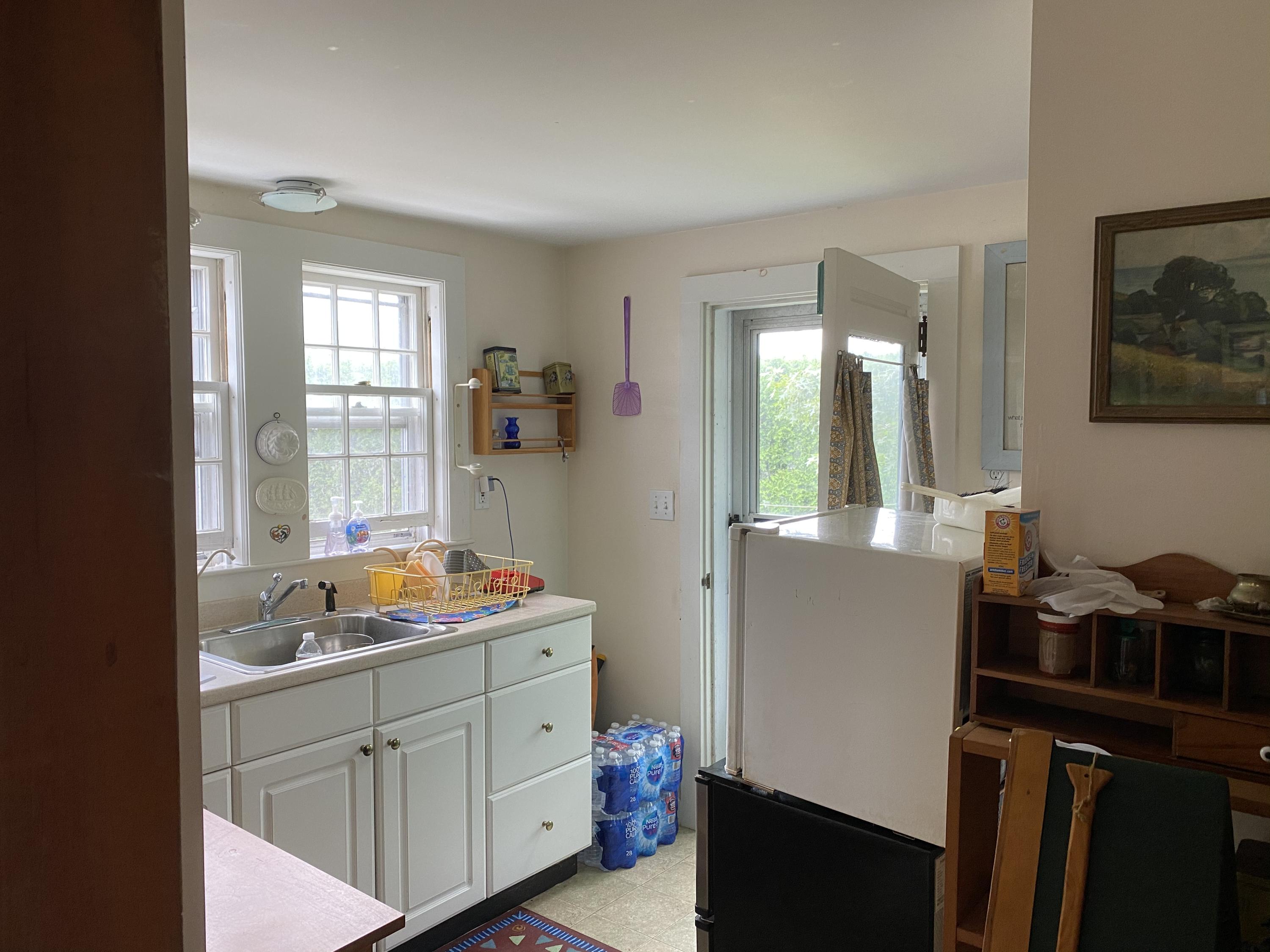 146 Mashnee Road Bourne, MA 02532 - Photo 14 of 32 a kitchen with a sink and cabinets