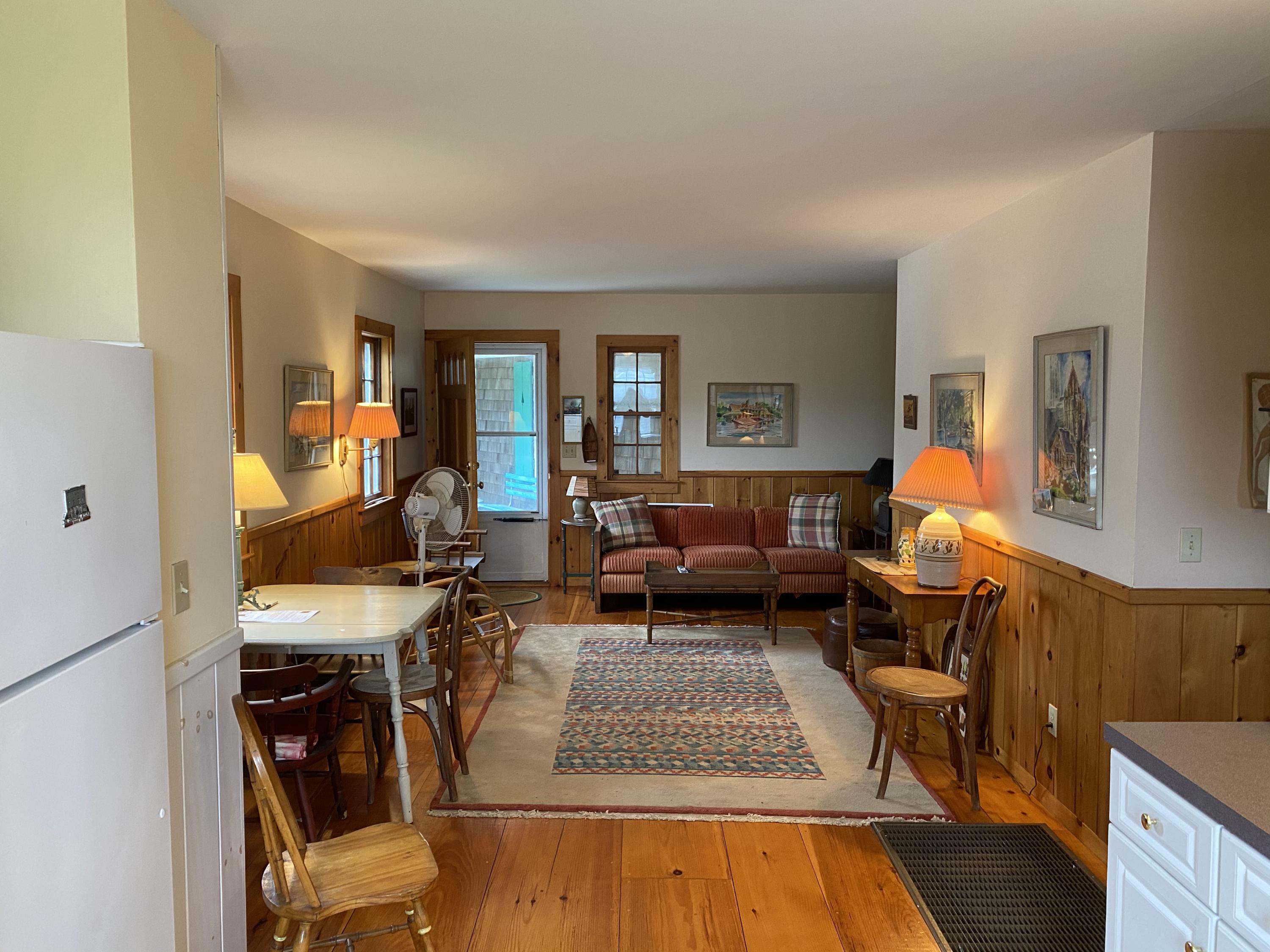 146 Mashnee Road Bourne, MA 02532 - Photo 7 of 32 a living room with furniture and a lamp