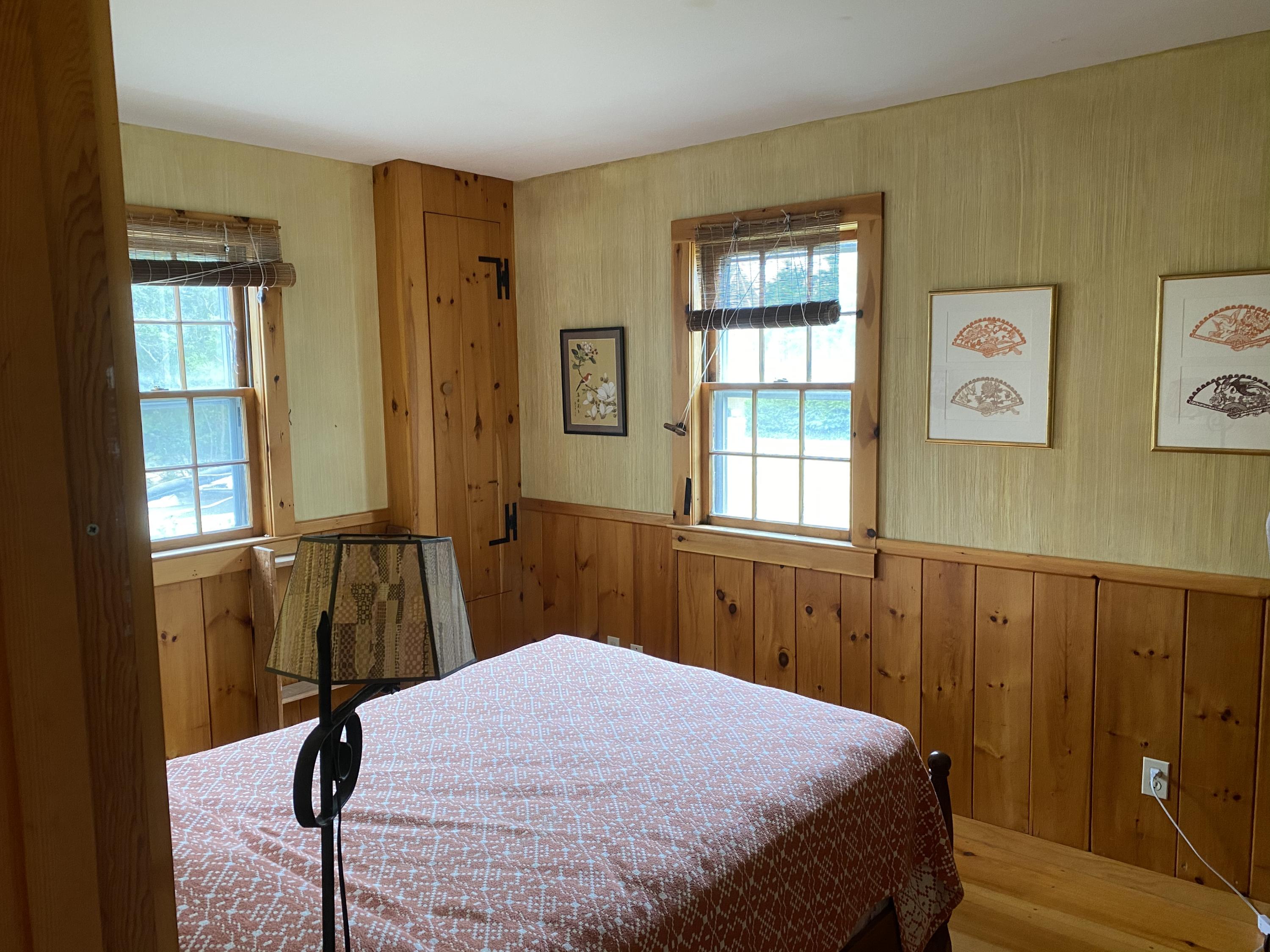 146 Mashnee Road Bourne, MA 02532 - Photo 8 of 32 a bedroom with a bed and wooden floor