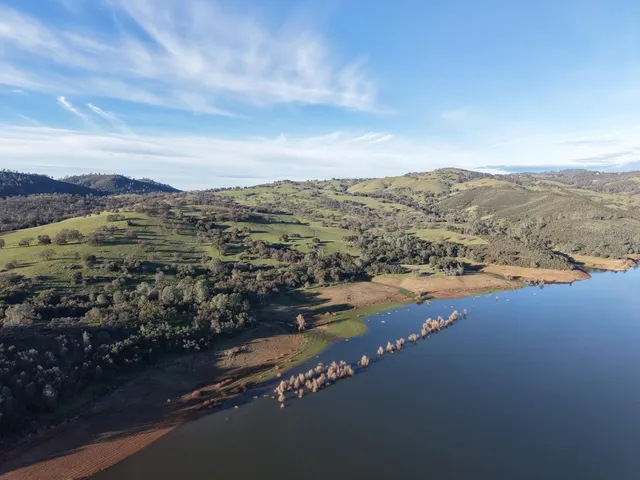 an aerial view of residential houses with outdoor space and river