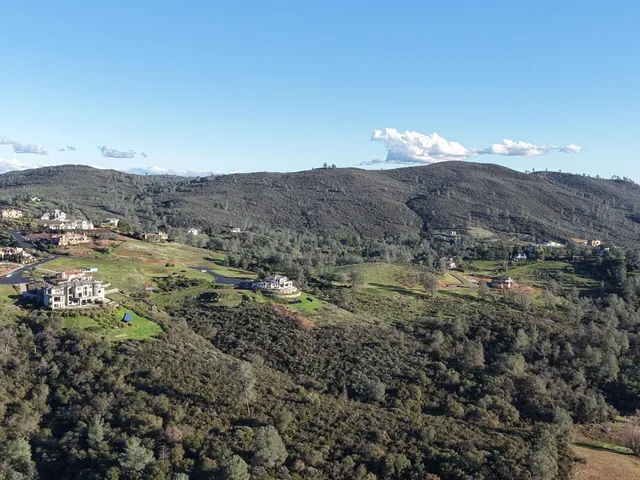 a view of a house with a mountain and a forest