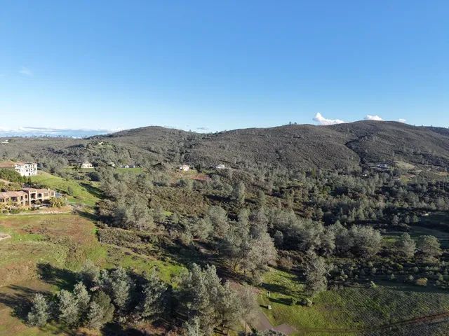 a view of a mountain range in a cloudy sky