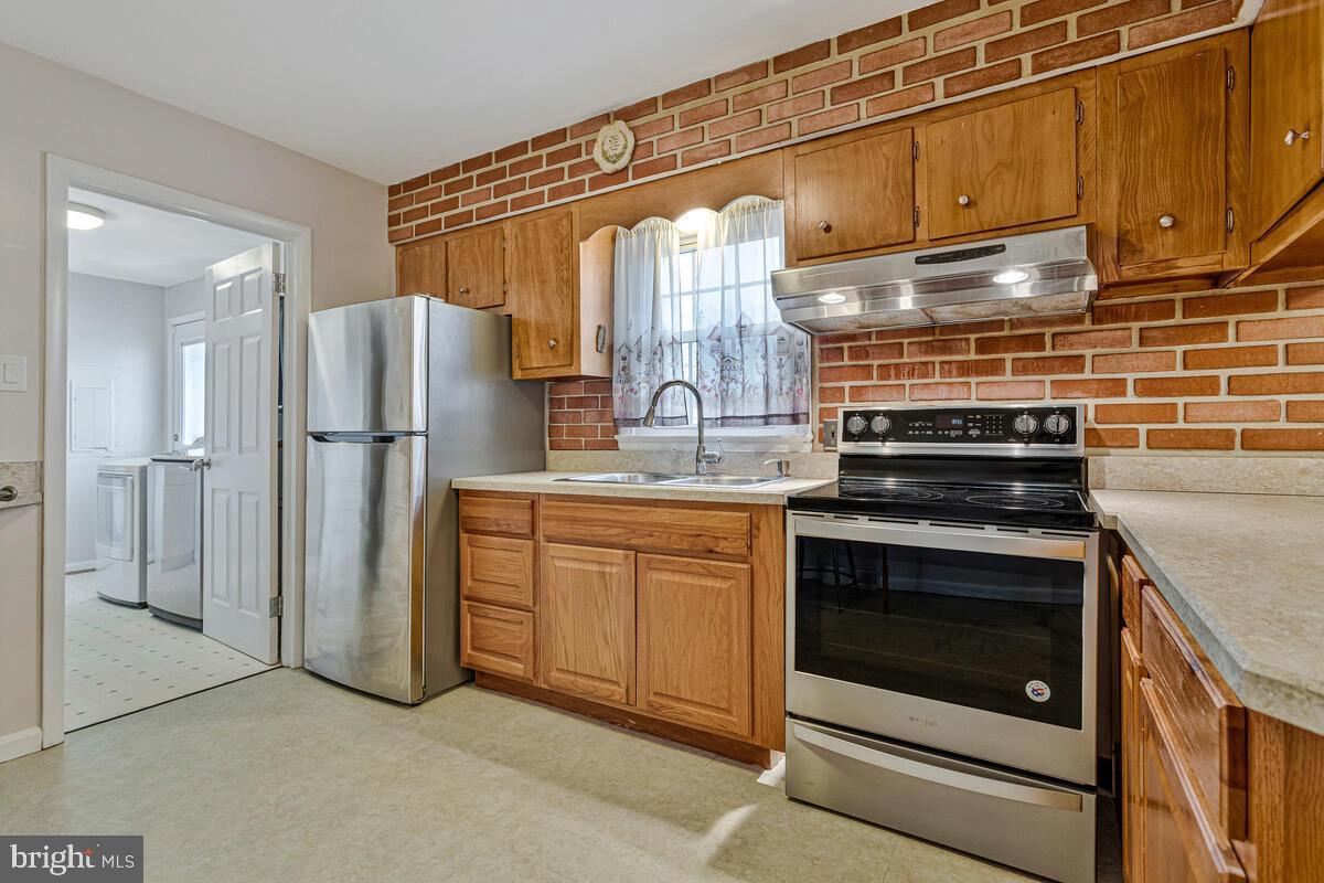 6015 Cracklingtown Road Hughesville, MD 20637 - Photo 3 of 17 a kitchen with stainless steel appliances granite countertop a refrigerator stove and sink