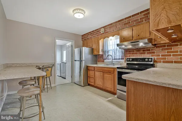 a kitchen with refrigerator and cabinets