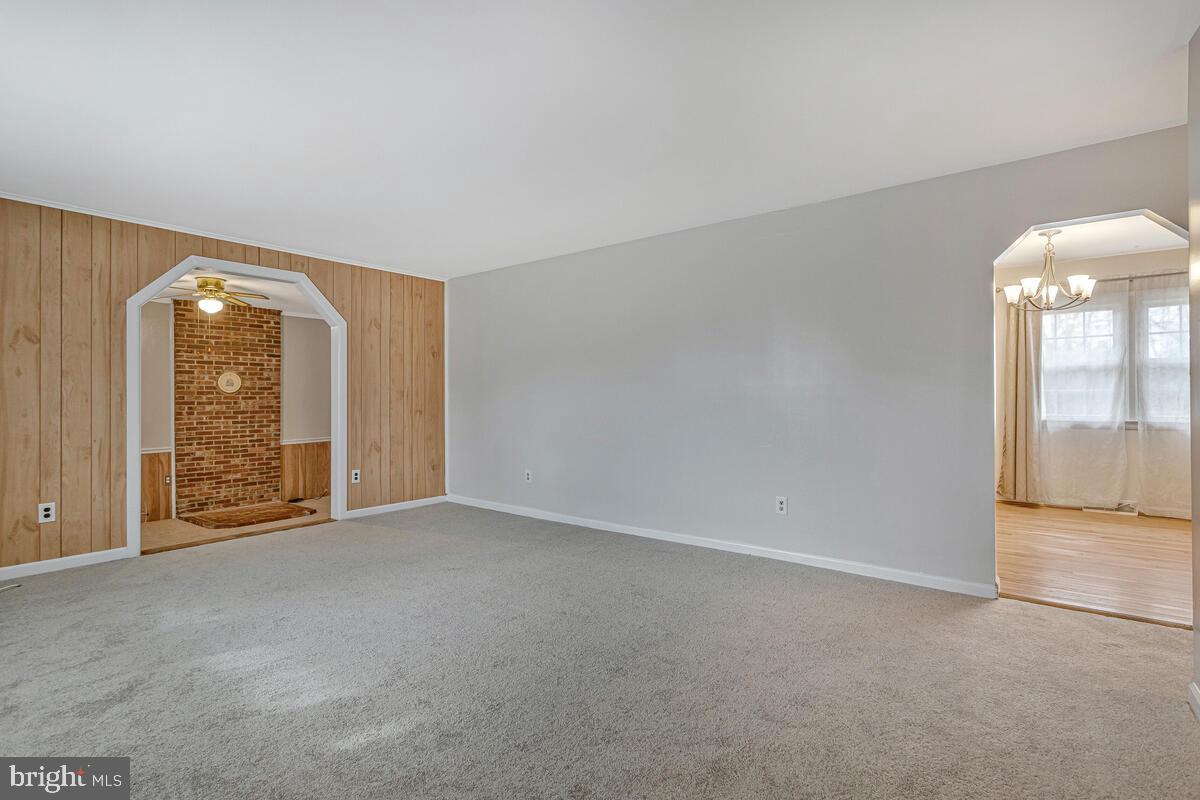 6015 Cracklingtown Road Hughesville, MD 20637 - Photo 8 of 17 an empty room with mirror and a door