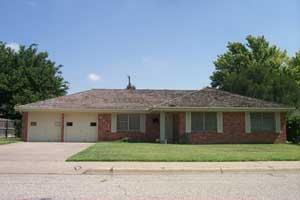 6012 Dreyfuss Road Amarillo, TX 79106 - Photo 1 of 1 a view of a white house with a small yard and a large window