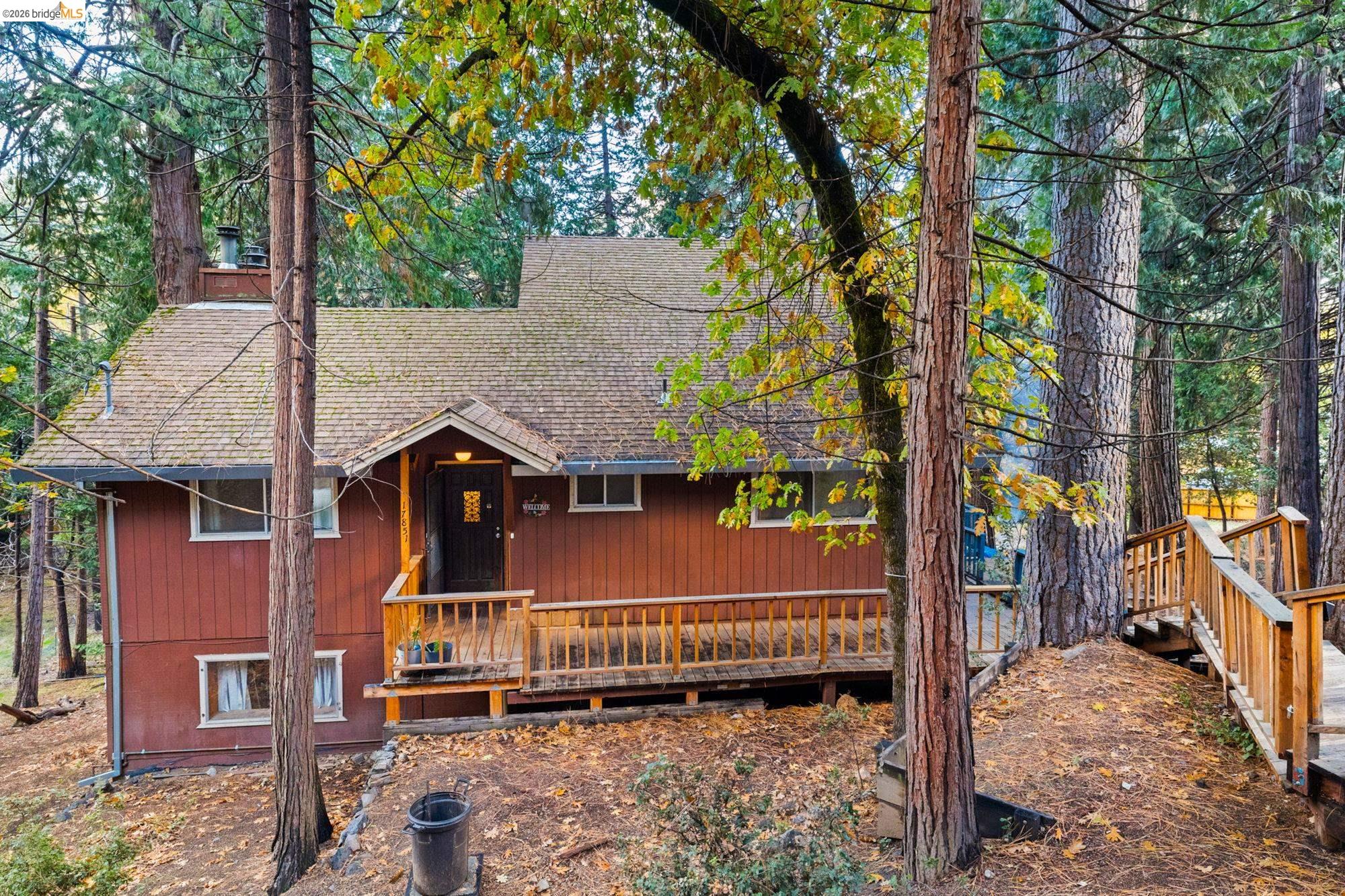 Rustic home with a shingled roof and a deck