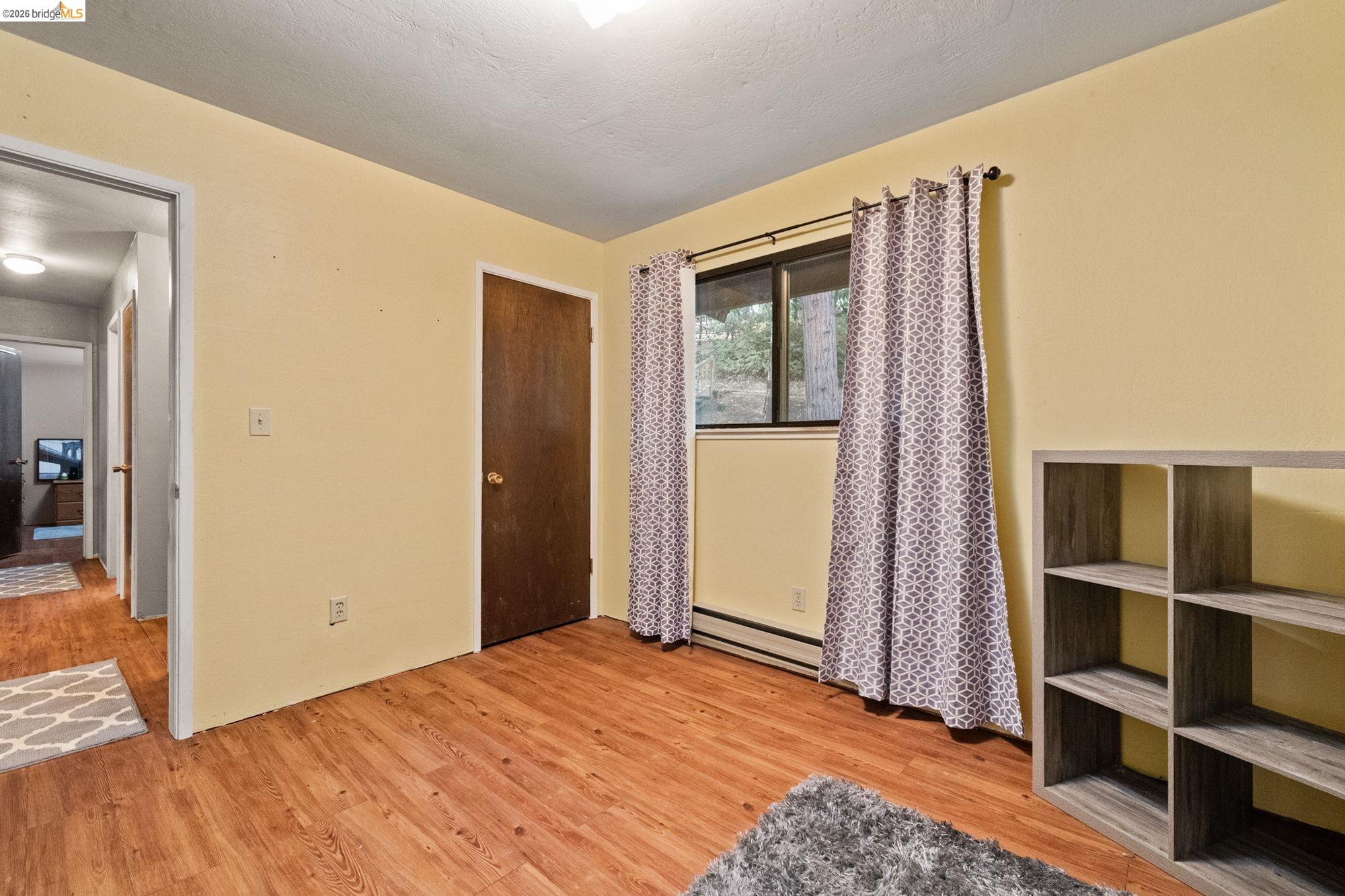 17851 Robin Road Twain Harte, CA 95383 - Photo 17 of 45 Unfurnished bedroom featuring light wood finished floors, a baseboard radiator, and a closet