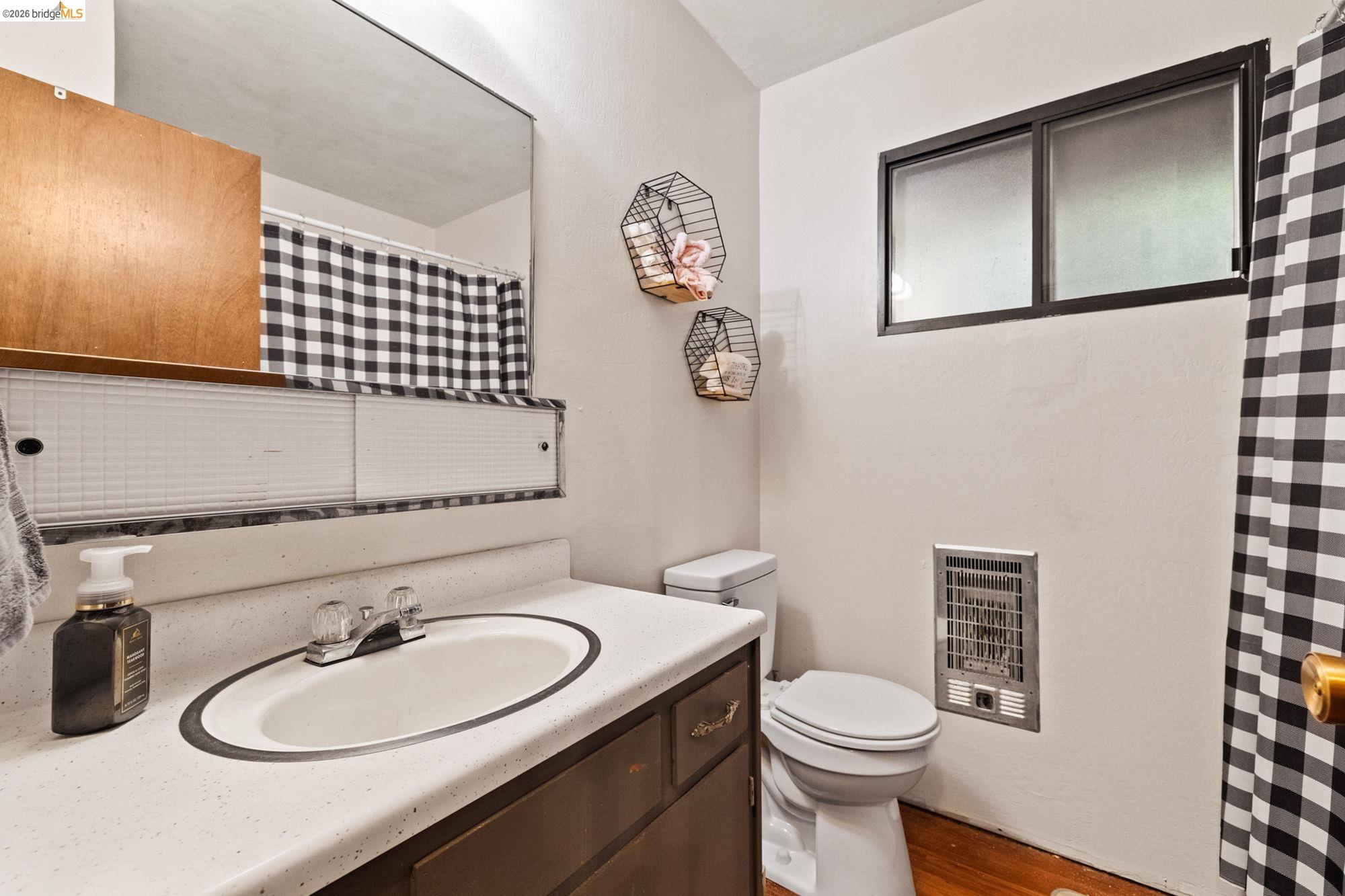 17851 Robin Road Twain Harte, CA 95383 - Photo 19 of 45 Bathroom with vanity, heating unit, wood finished floors, and a shower with curtain