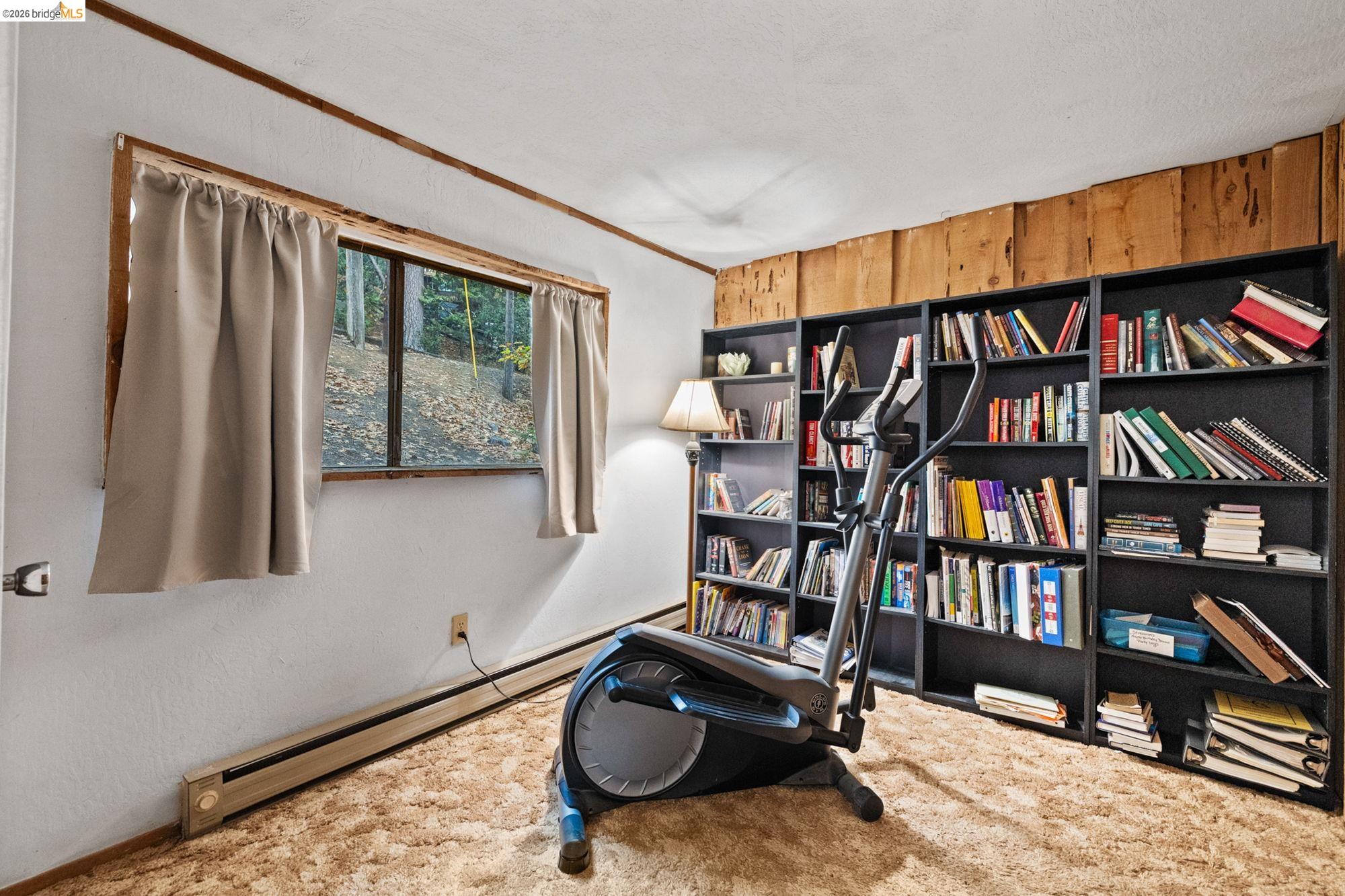 17851 Robin Road Twain Harte, CA 95383 - Photo 30 of 45 Living area with a baseboard radiator, carpet, and wooden walls