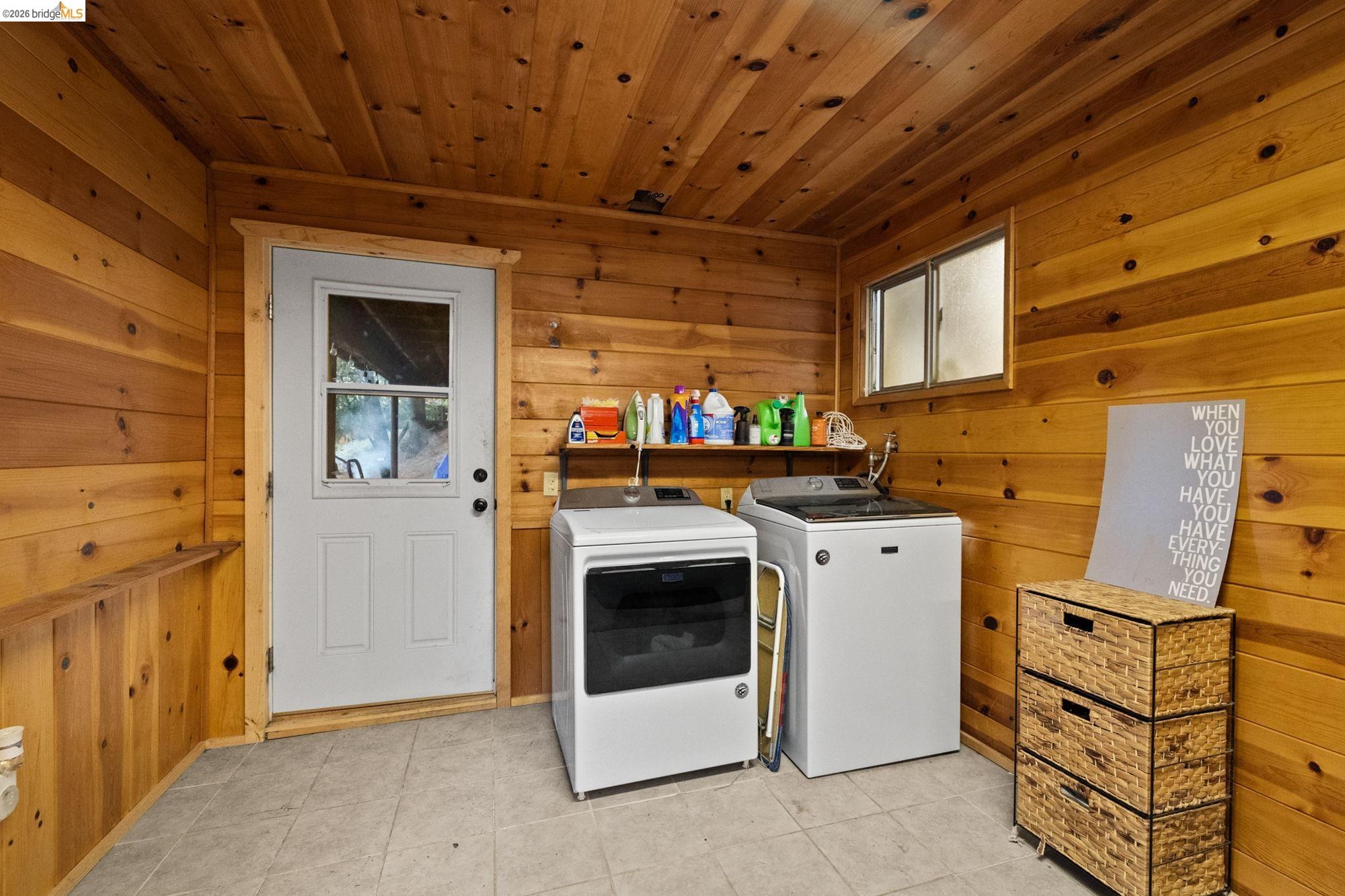 17851 Robin Road Twain Harte, CA 95383 - Photo 33 of 45 Laundry area featuring wood walls, separate washer and dryer, wood ceiling, and light tile patterned floors