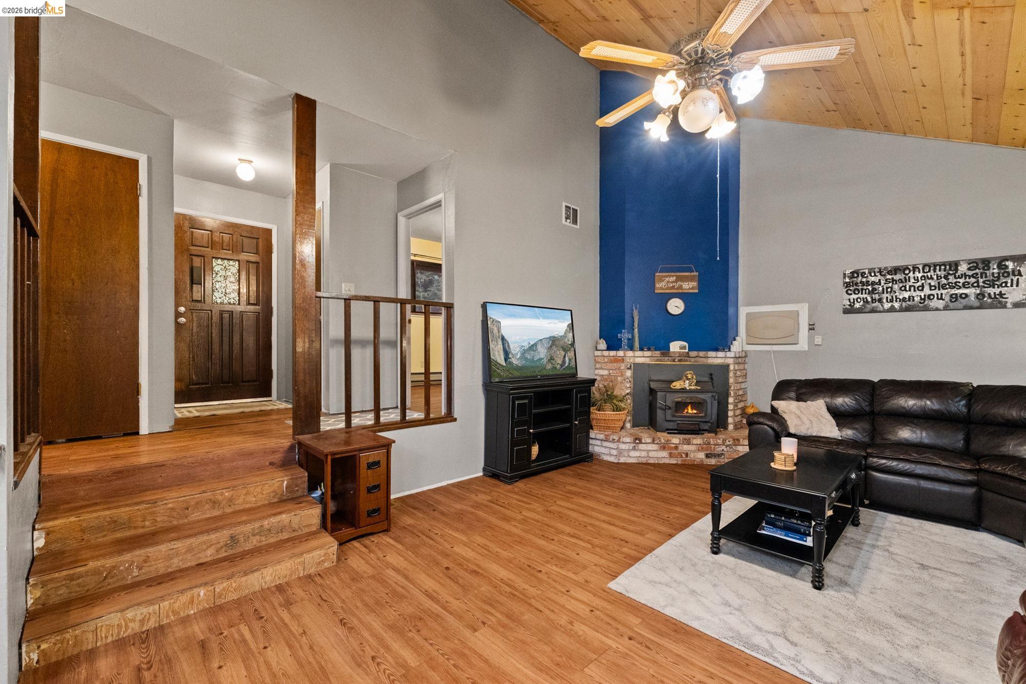 17851 Robin Road Twain Harte, CA 95383 - Photo 4 of 45 Living area featuring wood finished floors, a ceiling fan, a vaulted wooden ceiling, and a wood stove