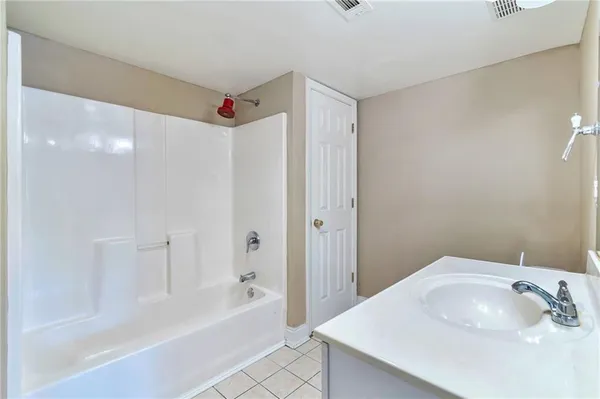 a bathroom with a bathtub a sink and a shower