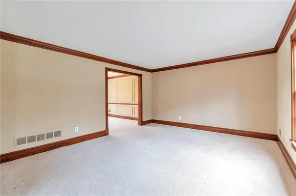 a view of an empty room with a window