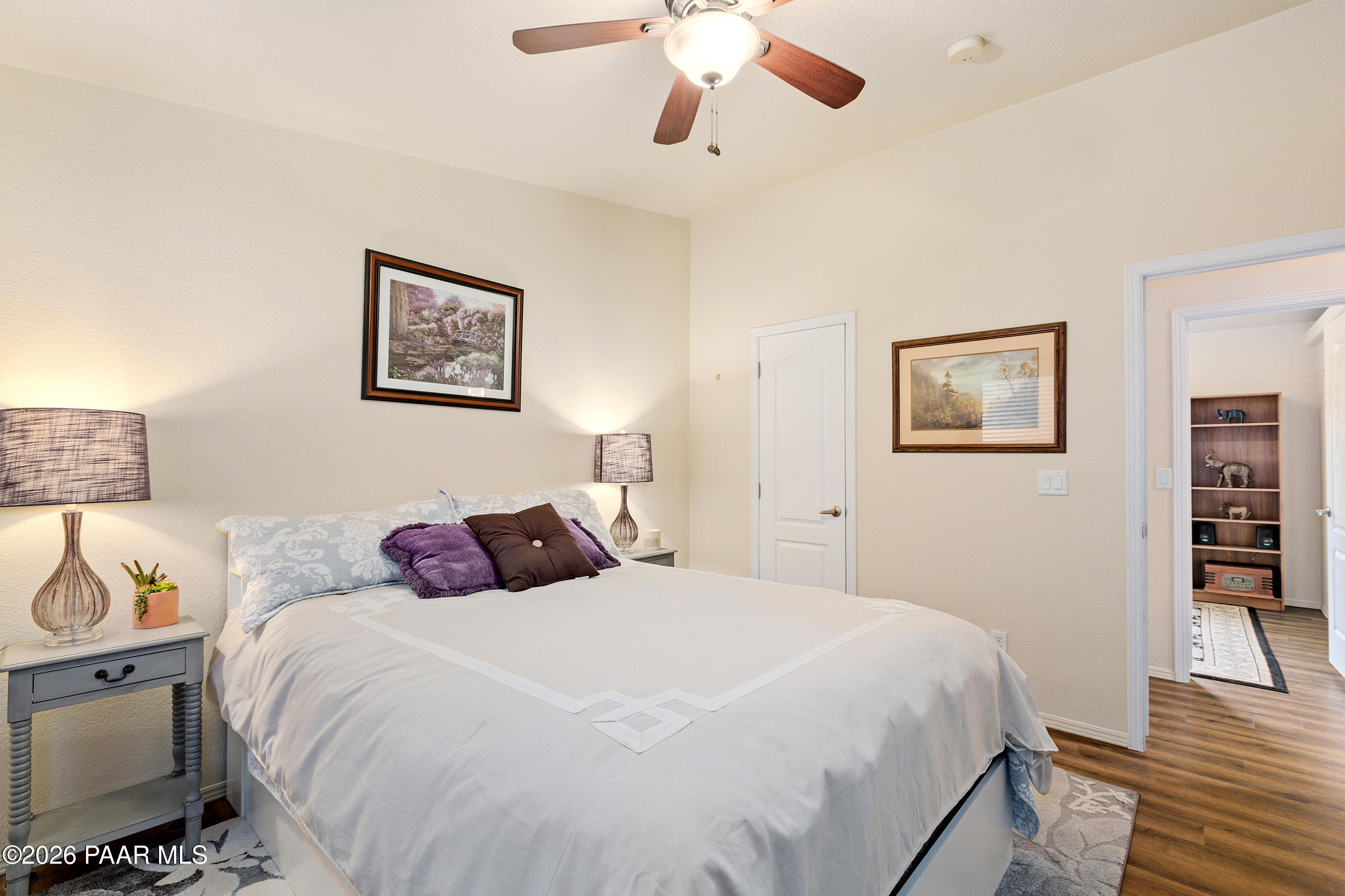 11250 East State Rte 69 Dewey, AZ 86327 - Photo 22 of 38 a bedroom with a large bed and a chandelier