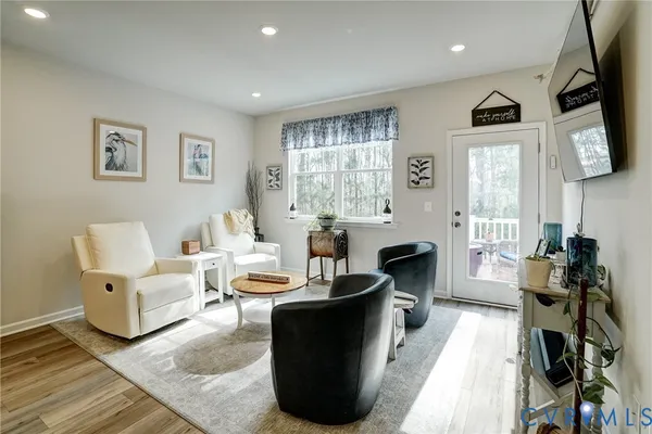 a large bedroom with a bed and a flat screen tv