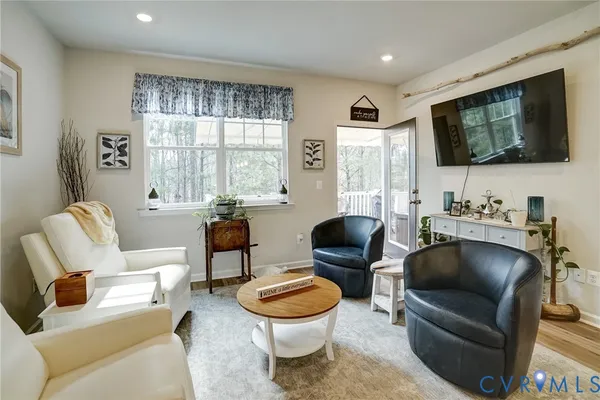 a living room with couches and a flat screen tv