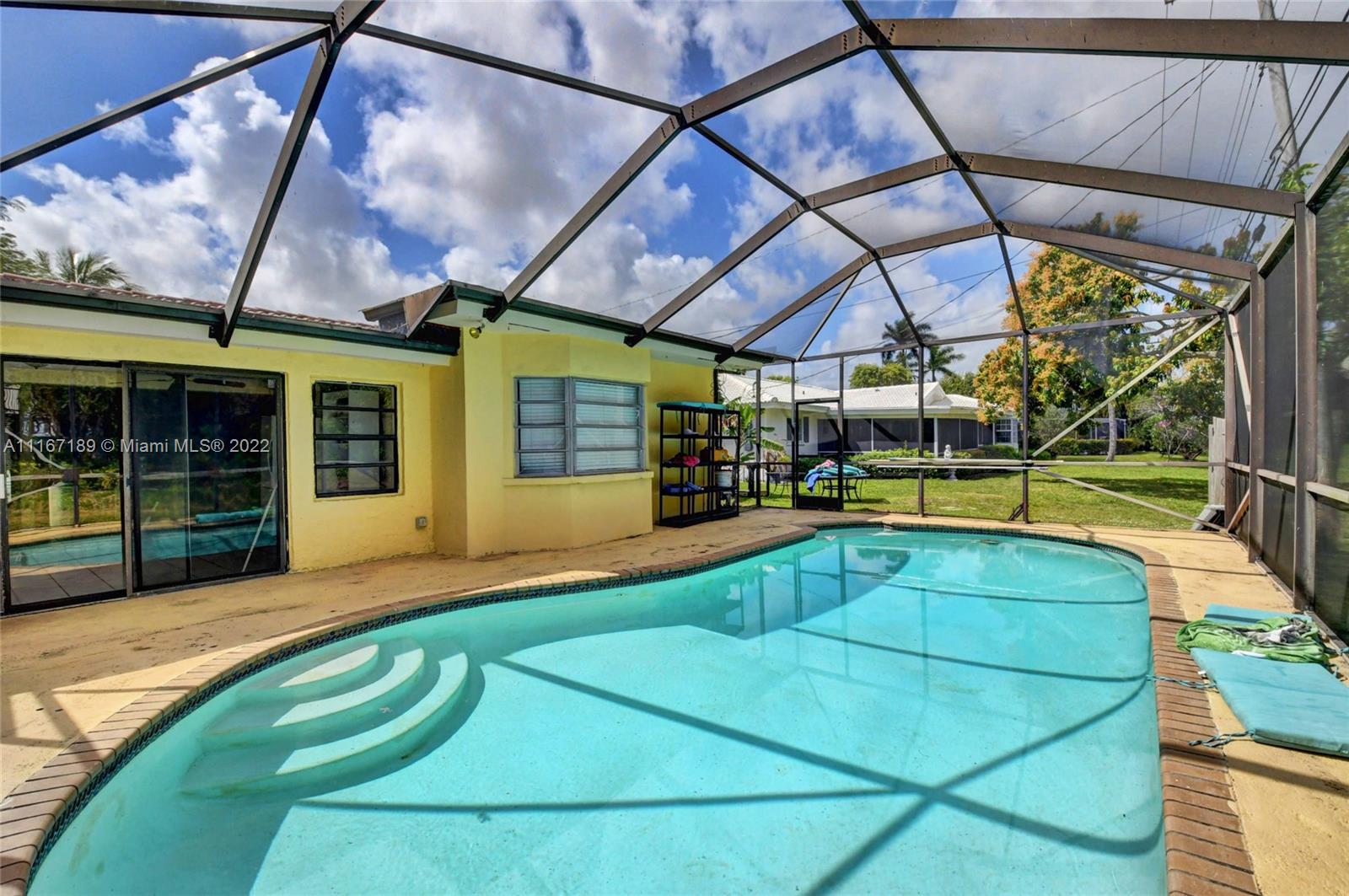 1945 North Conference Drive Boca Raton, FL 33486 - Photo 1 of 19 a view of a backyard with a small swimming pool