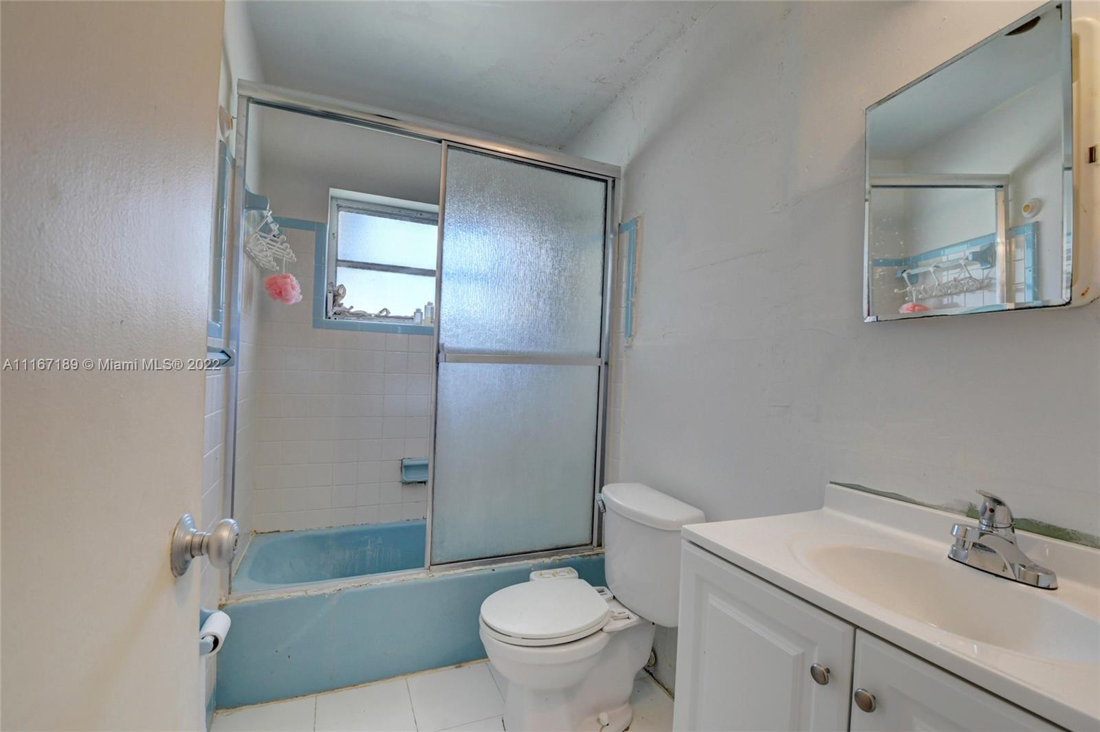 1945 North Conference Drive Boca Raton, FL 33486 - Photo 14 of 19 a bathroom with a sink a toilet and shower