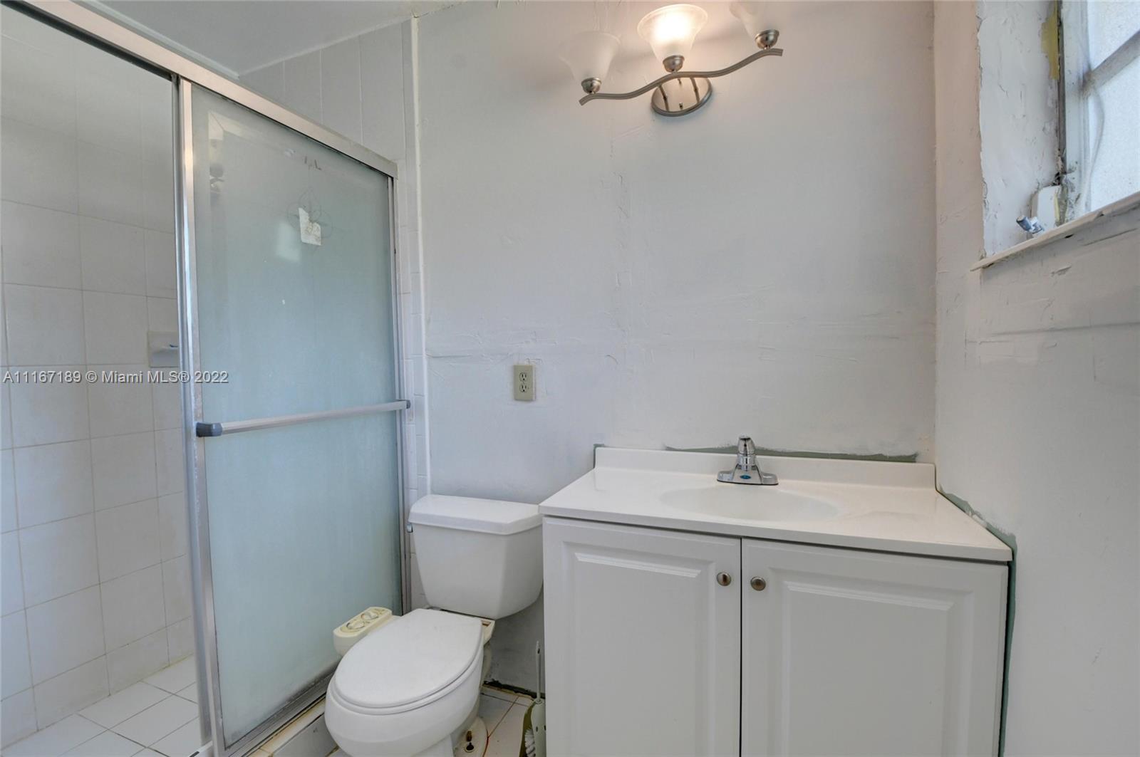 1945 North Conference Drive Boca Raton, FL 33486 - Photo 16 of 19 a bathroom with a sink a toilet and shower