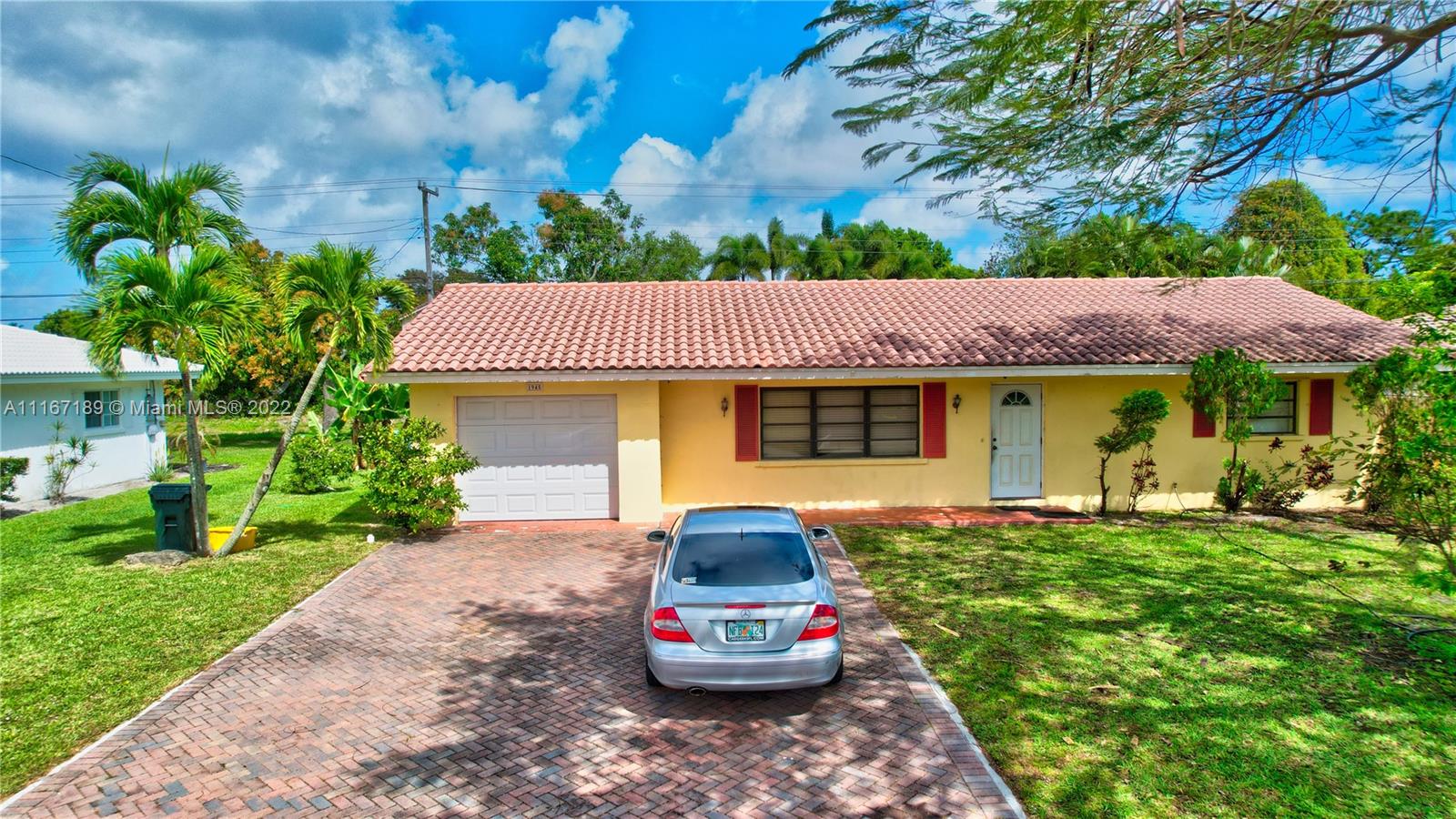 1945 North Conference Drive Boca Raton, FL 33486 - Photo 2 of 19 a front view of a house with a yard