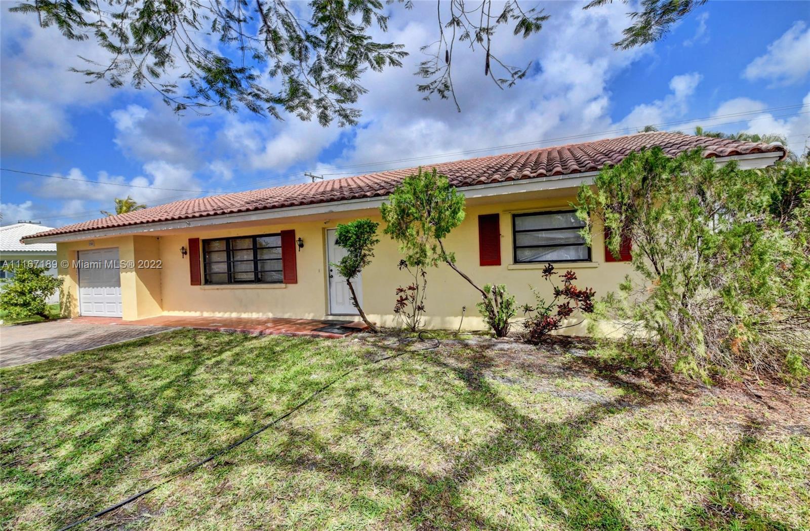 1945 North Conference Drive Boca Raton, FL 33486 - Photo 6 of 19 front view of house with a yard