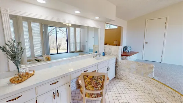 a spacious bathroom with a granite countertop tub and a sink