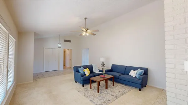 a living room with furniture and a chandelier