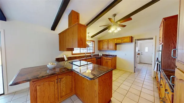 a kitchen with stainless steel appliances granite countertop a sink and a stove