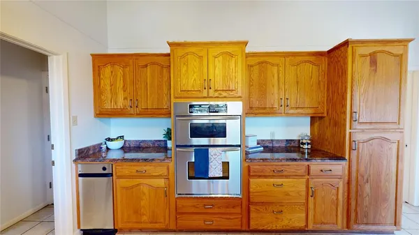 a kitchen with stainless steel appliances granite countertop a stove and refrigerator