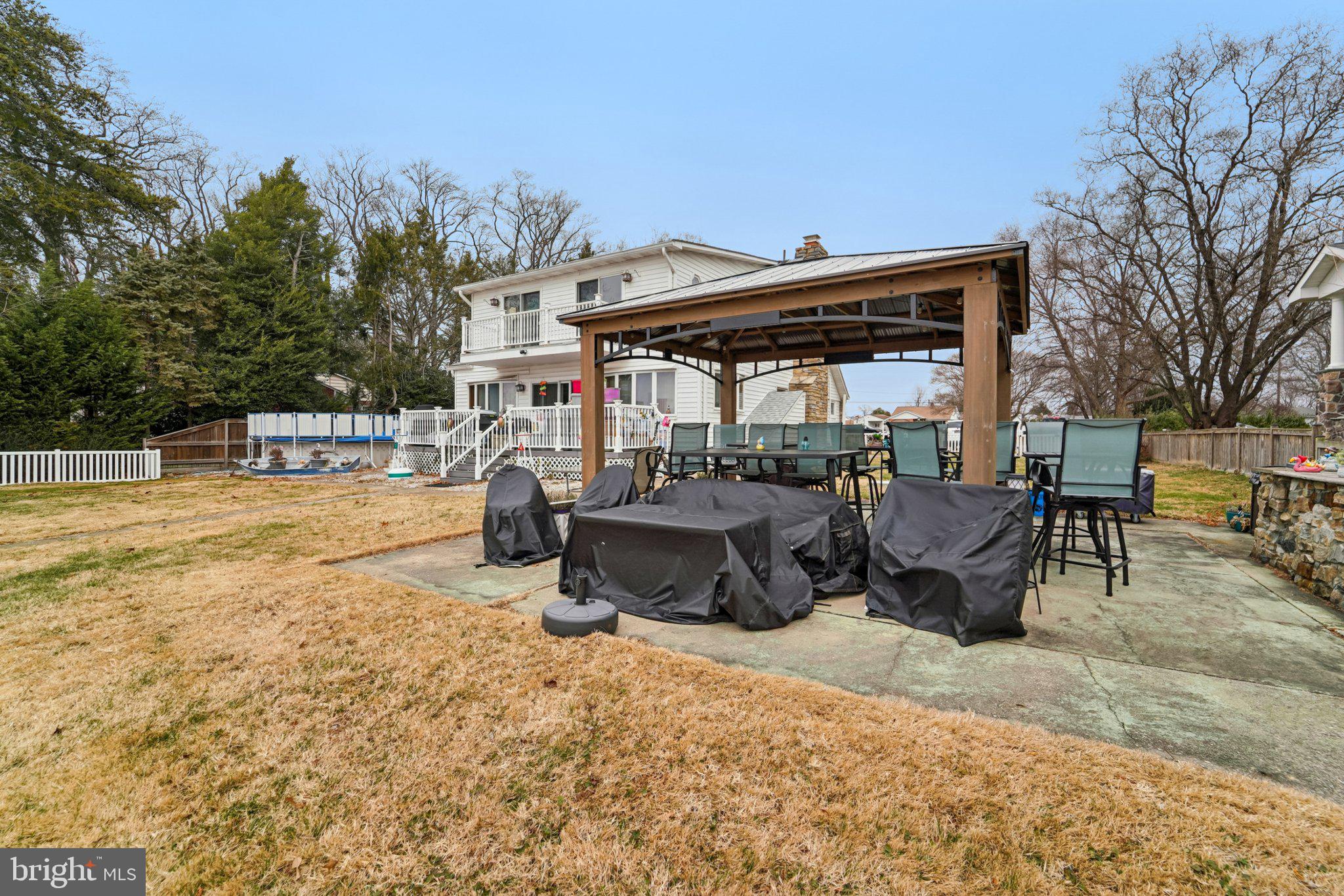 1507 Shore Road Baltimore, MD 21220 - Photo 15 of 46 a roof deck with table and chairs a barbeque and potted plants by side of it