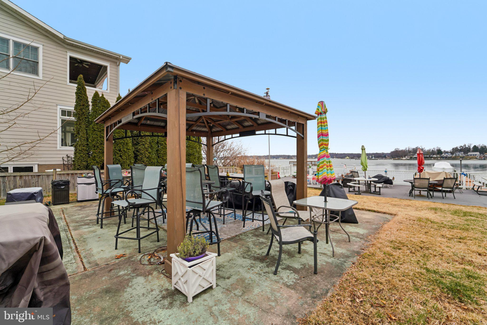 1507 Shore Road Baltimore, MD 21220 - Photo 16 of 46 a view of a patio with a dining table and chairs and couches