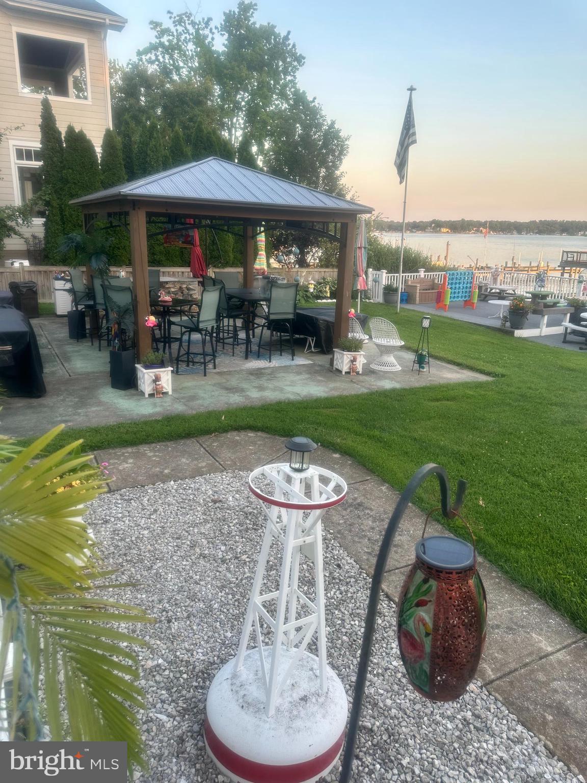1507 Shore Road Baltimore, MD 21220 - Photo 4 of 46 a view of a backyard with table and chairs potted plants and a fountain