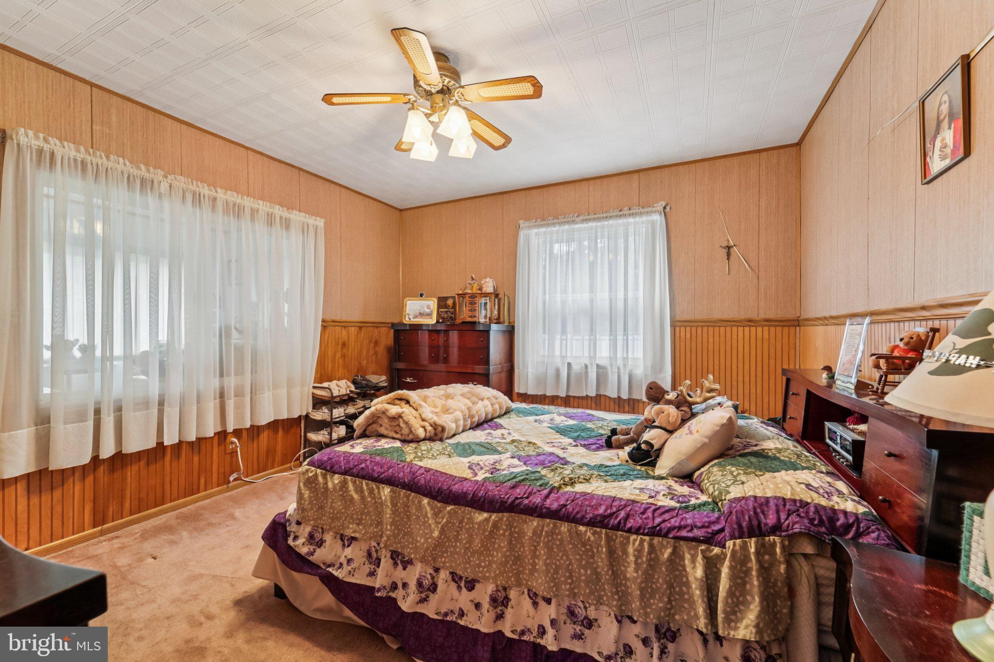 1507 Shore Road Baltimore, MD 21220 - Photo 41 of 46 a bedroom with a bed and a chandelier