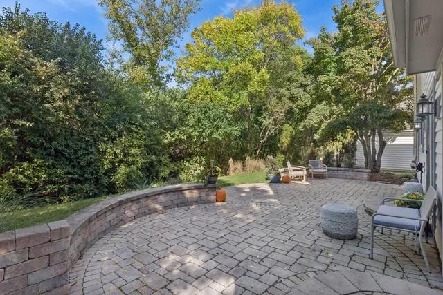 a view of a backyard with table and chairs