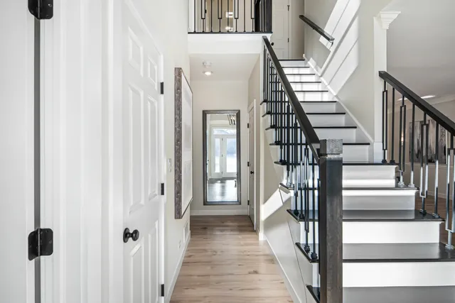 a view of a hallway with wooden floor and entryway