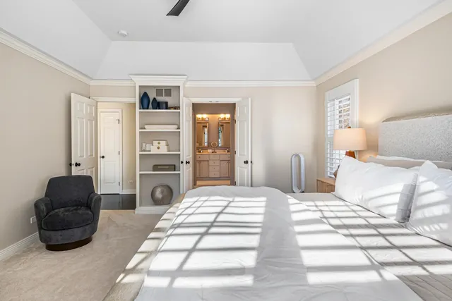 a bedroom with a bed a couch and dresser