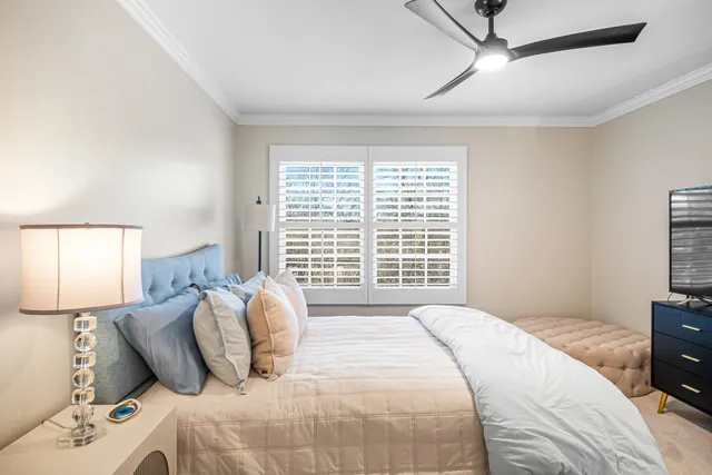 a bedroom with a large bed and a window