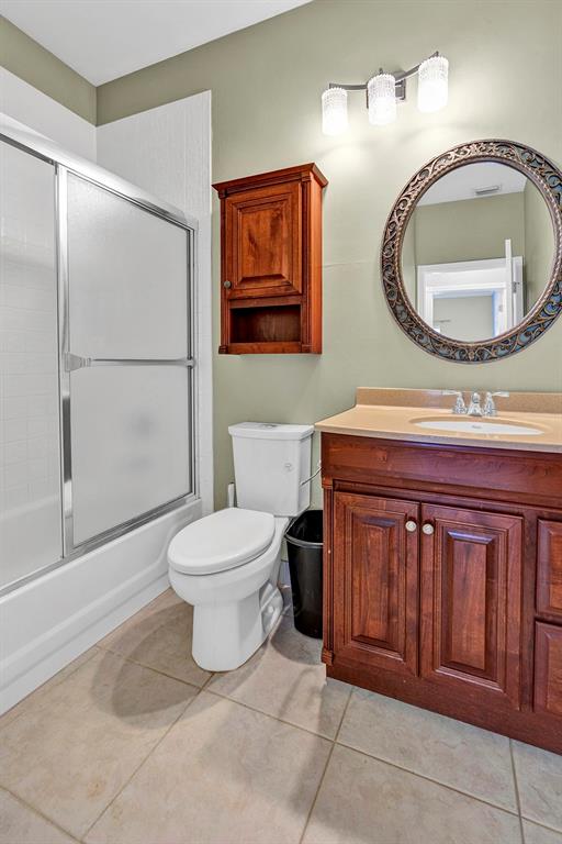 19571 Black Olive Lane Boca Raton, FL 33498 - Photo 22 of 61 a bathroom with a toilet a sink and mirror