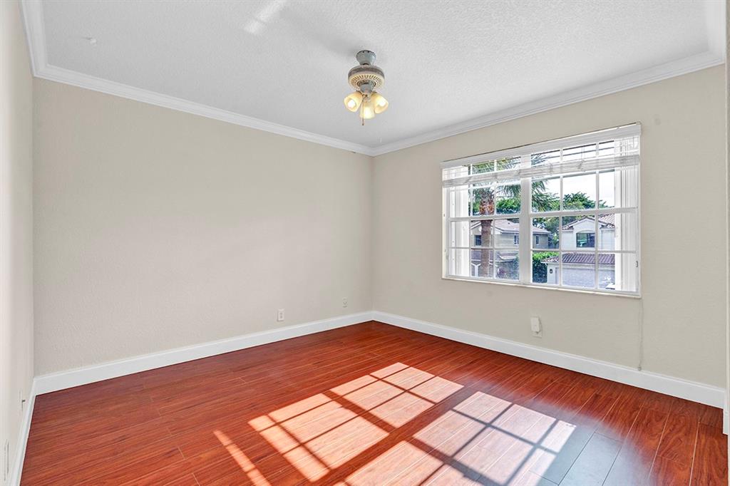 19571 Black Olive Lane Boca Raton, FL 33498 - Photo 32 of 61 a view of empty room with wooden floor and fan