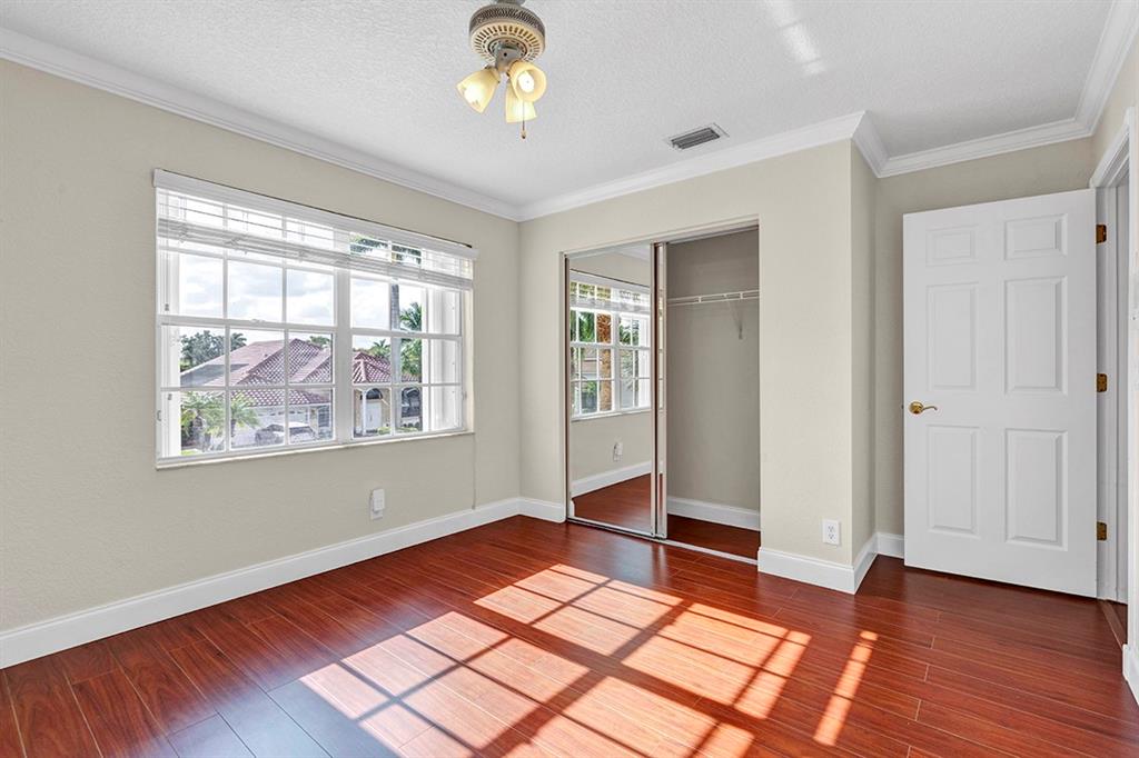 19571 Black Olive Lane Boca Raton, FL 33498 - Photo 36 of 61 an empty room with wooden floor and windows
