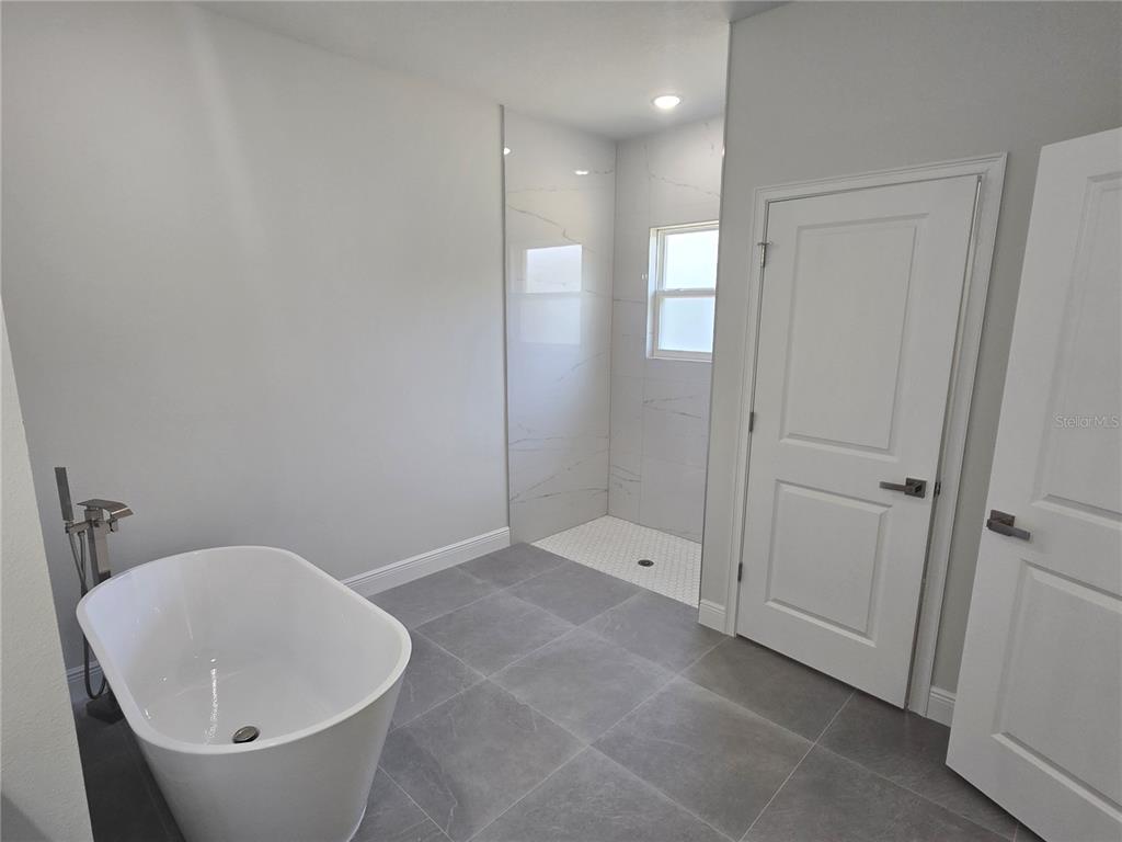 2644 Southwest 162nd Street Road Ocala, FL 34473 - Photo 26 of 47 a bathroom with a bathtub and shower