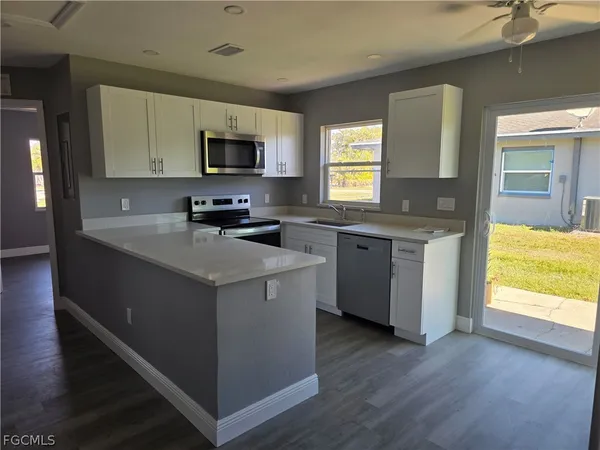 a kitchen that has a sink and a stove in it