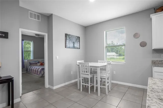 a kitchen with stainless steel appliances granite countertop a stove a sink a refrigerator and a refrigerator