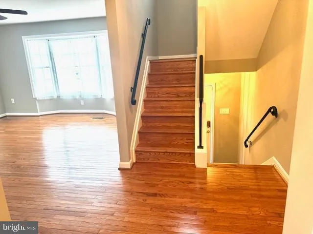 a view of a room with wooden floor and windows