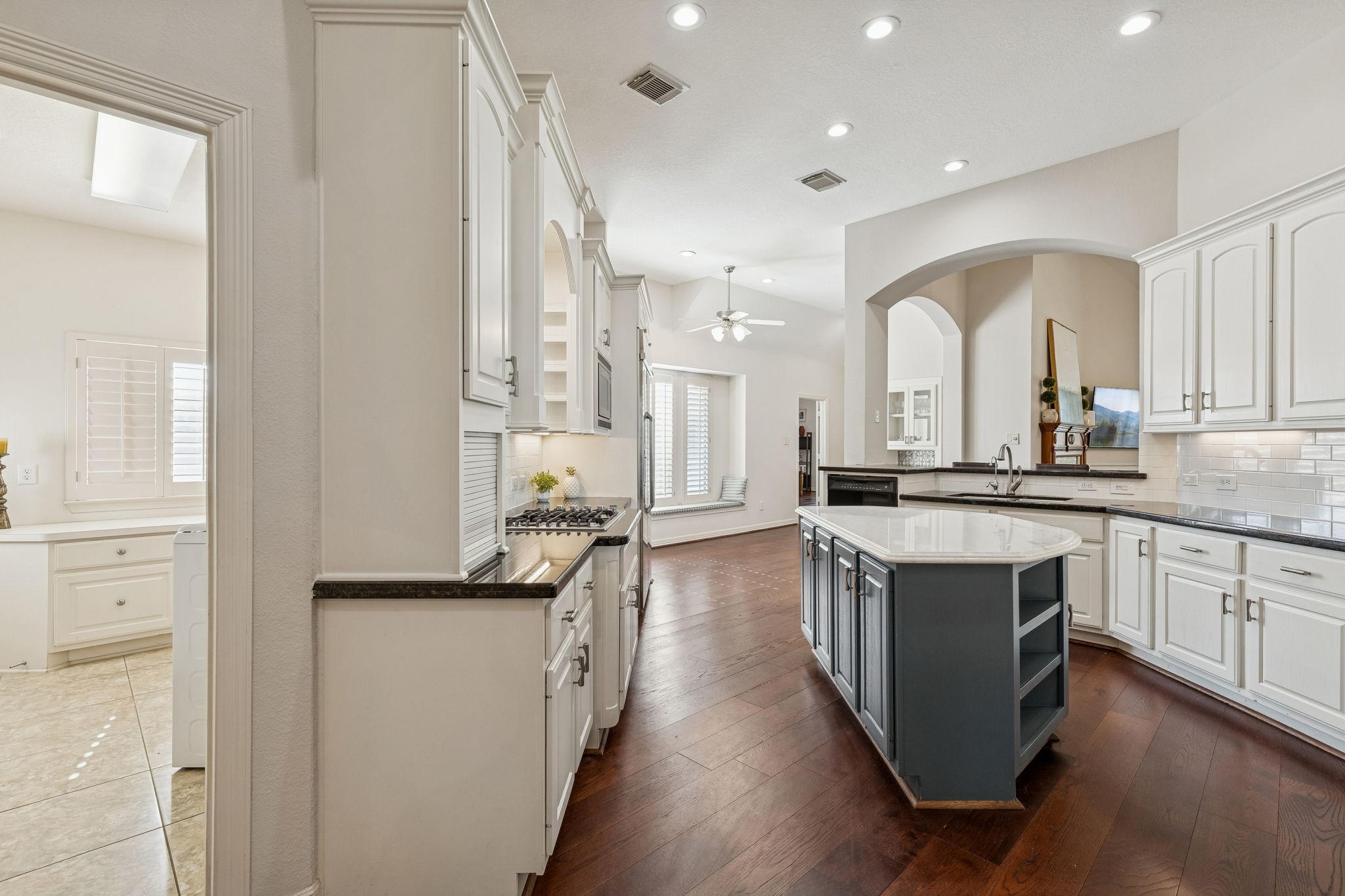 2202 Britton Ridge Drive Katy, TX 77494 - Photo 8 of 41 This gourmet kitchen features a blue central island and rich white cabinetry. Elegant granite countertops and a subway tile backsplash complete the look in this space that stays perfectly open to the family room.