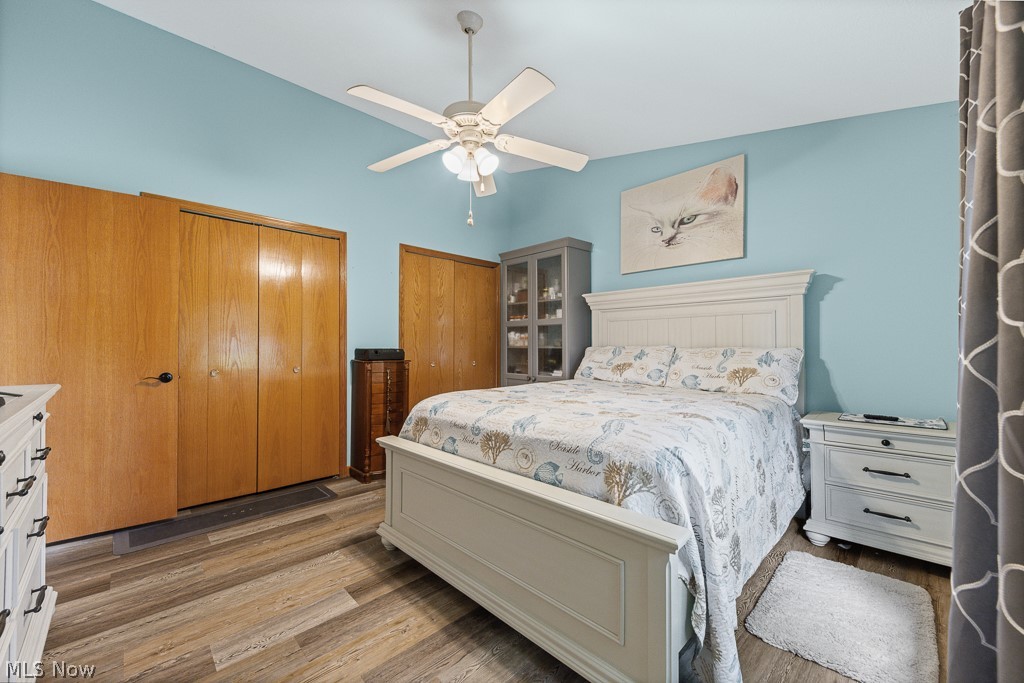 808 Ryan Road, Unit 14 Medina, OH 44256 - Photo 21 of 40 Bedroom featuring wood-finish flooring, two sets of bi-fold closets, and a ceiling fan with integrated lighting